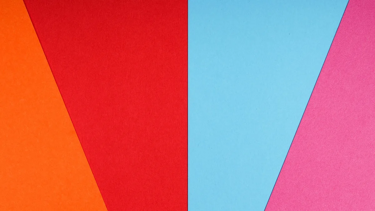 Overhead shot of brightly coloured sheets of paper arranged in an overlapping abstract pattern
