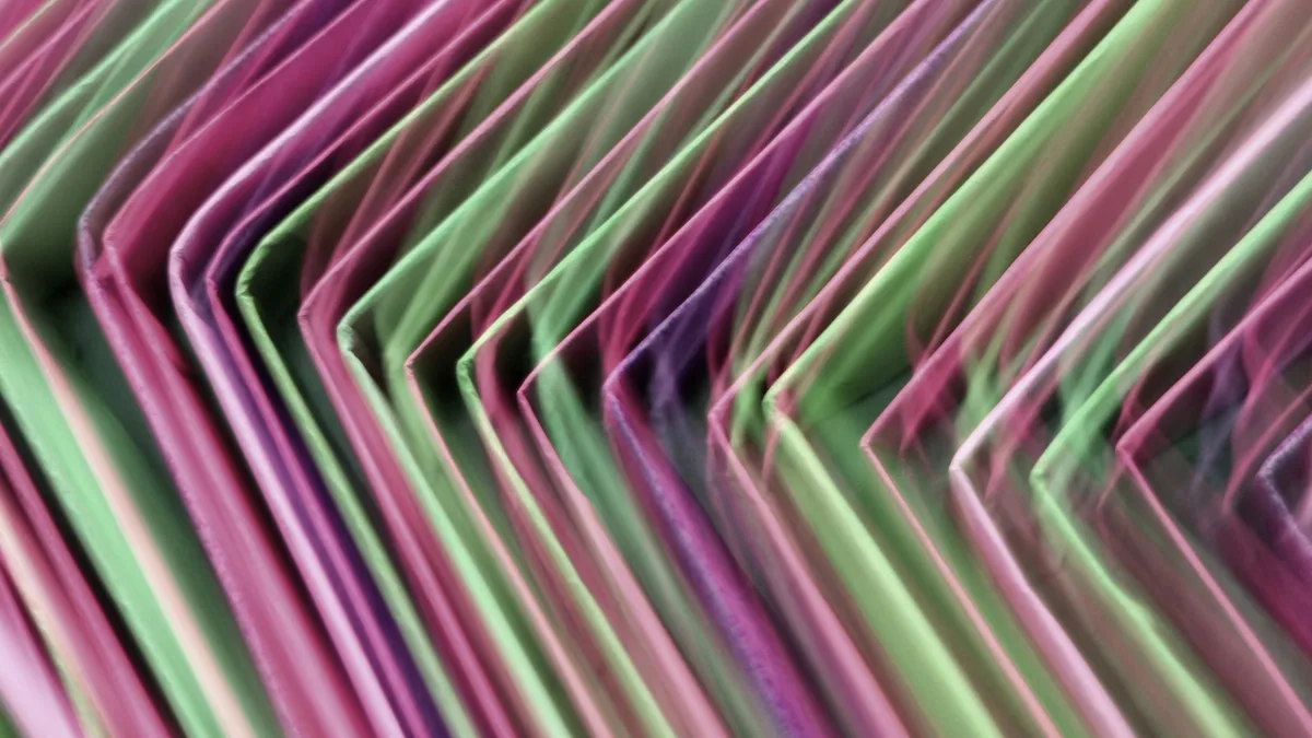 Brightly coloured document folders photographed with motion blur, suggesting files in different formats